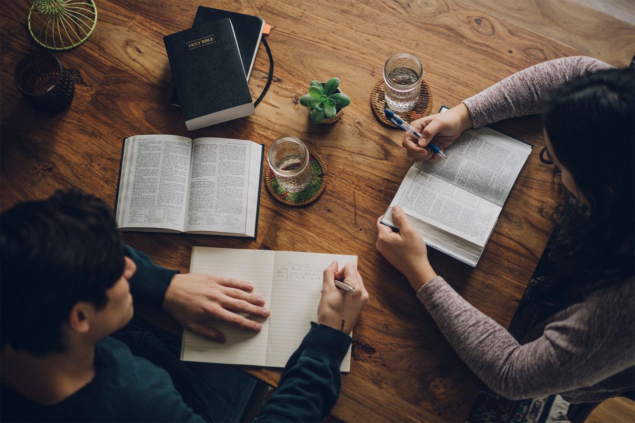 Um casal estuda o Livro de Mórmon à mesa da cozinha aprendendo sobre o Espírito Santo